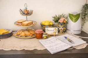 a table topped with plates of food and bread at Centro-Archimede Rooms in Castelvetrano Selinunte
