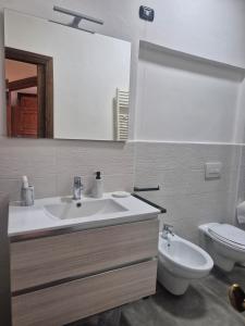 a bathroom with a sink and a toilet at Dimora del Funaro con parcheggio in Orvieto +8 photos
