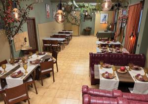 a dining room with tables and chairs with food on them at Арт Спектър Камп in Bratsigovo
