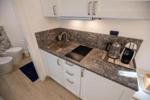 a kitchen with a sink and a counter top at Gli Oleandri in Bellano +42 photos