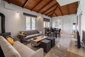 a living room with a couch and a table at Zafeiris House in Kalívia Thorikoú