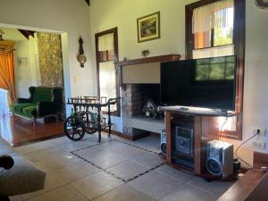a living room with a flat screen tv and a fireplace at Rincón del Cielo Country Club in Merlo
