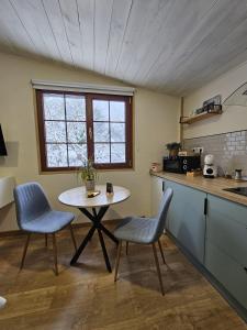 a kitchen with a table and two chairs and a table at Solapetxea Loft rural in Elosu