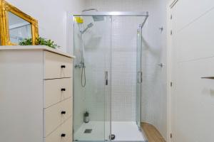 a shower with a glass door in a bathroom at The Art Flat in Figueres