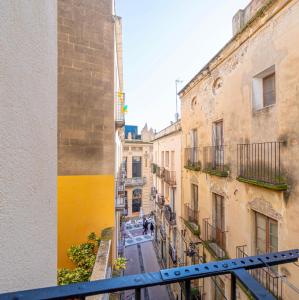 a view of an alley from a balcony in a building at The Art Flat in Figueres