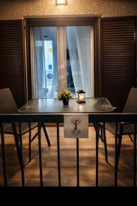 a table with a candle sitting on top of it at Olive tree Apartment Kanoni in Kanoni +10 photos
