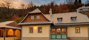 a large white house with a wooden roof at Villa Lucia in Banská Štiavnica