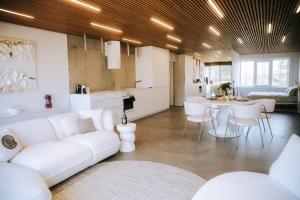 a living room with a white couch and a table at The living gallery in Roja +19 photos