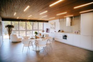 a kitchen and dining room with a table and chairs at The living gallery in Roja