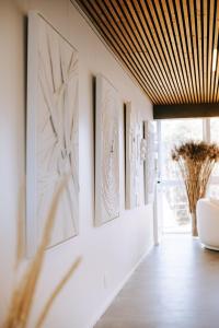 a hallway with art on the walls of a house at The living gallery in Roja