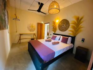 a bedroom with a bed with two towels on it at Hotelito Sri Lanka in Weligama +83 photos
