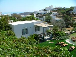 a white house with a view of a city at Myrto Bungalows in Artemonas