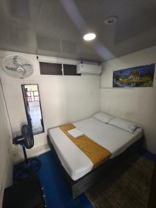 a small bedroom with a bed and a fan at Gaia Rodadero in Santa Marta +22 photos