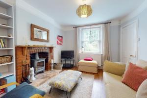 a living room with a couch and a fireplace at High Bank Porlock in Porlock