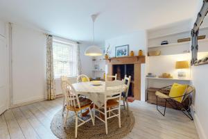 a dining room with a table and chairs and a fireplace at High Bank Porlock in Porlock