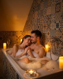 a man and woman sitting in a bath tub at Villa Lucia in Banská Štiavnica +130 photos