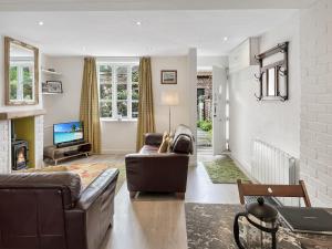 a living room with a couch and a tv at Grace Cottage Porlock in Porlock