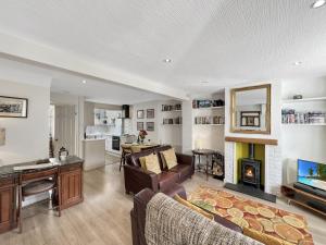 a living room with a couch and a fireplace at Grace Cottage Porlock in Porlock