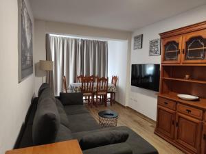 a living room with a couch and a table at Blue Ocean Apartments in Benalmádena