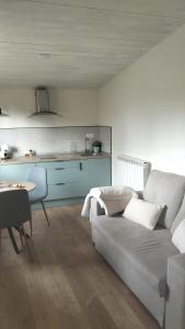 a living room with a couch and a kitchen at Solapetxea Loft rural in Elosu
