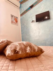 a pillow sitting on a bed in a bedroom at Alloggio nel Borgo Marinaro in Cittadella del Capo