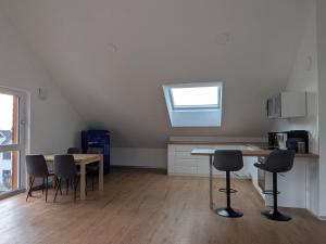 a kitchen with a table and chairs in a room at LechApartments in Kaufering