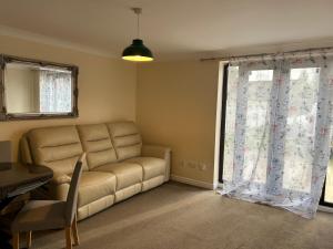 a living room with a couch and a window at Stylish 2-Bed Apartment with Parking in CBG