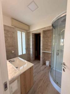 a bathroom with a sink and a glass shower at B&B Battista in Sacile