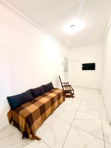a bedroom with a bed in a white room at Torres Residence 2 in Recife
