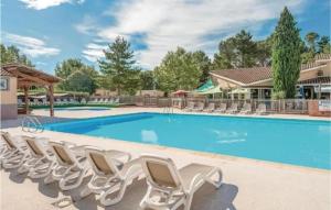 a swimming pool with lounge chairs around it at Maison dans village de vacances 5 pers climatisé piscine in Gaujac