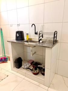 a kitchen counter with a sink and some pots and pans at Torres Residence 2 in Recife +5 photos
