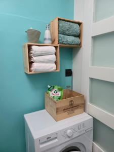 a small laundry room with a washer and dryer at Gîte bleu avec piscine chauffée couverte, Bozouls, Aveyron in Bozouls