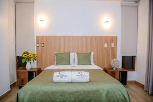 a bedroom with a large bed with two pillows on it at HOTEL TERRANOVA Abancay in Abancay