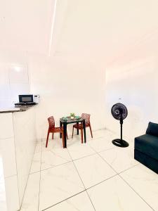 a living room with a table and chairs at Torres Residence 2 in Recife