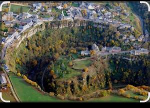 an aerial view of a town with houses and trees at Gîte bleu avec piscine chauffée couverte, Bozouls, Aveyron in Bozouls