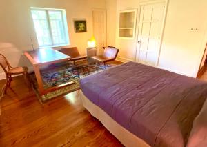 a bedroom with a bed and a desk and a table at 2 Born Wealthy in 1926 in Elkins Park