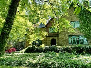 a large brick house with trees in front of it at 2 Born Wealthy in 1926 in Elkins Park +11 photos