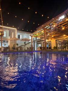 a swimming pool in a building at night at Aylane Aparth Hotel in Nampula