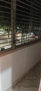 a window in a room with a view of a street at kanakdhara aashraya in Vrindāvan