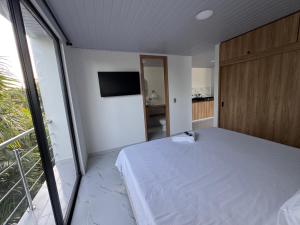 a bedroom with a bed and a large window at Dos palmas in Granada