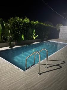 a swimming pool at night with rails in it at Dos palmas in Granada