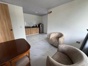 a living room with two chairs and a table at Dos palmas in Granada