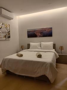 a bedroom with a large bed with two hats on it at Blue bay Sliema in Sliema