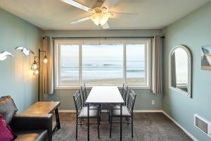 a dining room with a table and a view of the ocean at Sea Gypsy Rentals in Lincoln City