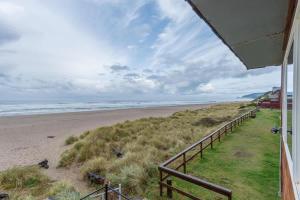a view of the beach from the balcony of a house at Sea Gypsy Rentals in Lincoln City