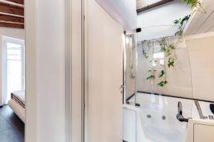 a bathroom with a tub and a sink at Terrazzo apartment in Bellagio +33 photos