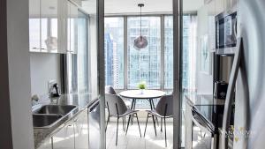 a kitchen with a table and chairs in a room at Vancouver Extended Stay in Vancouver