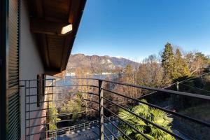 a balcony with a view of a river and mountains at Terrazzo apartment in Bellagio