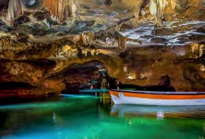 a boat in the water in a cave at Les Coves de Lluna in Vall de Uxó