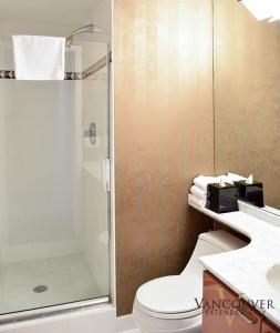 a bathroom with a shower and a toilet and a sink at Vancouver Extended Stay in Vancouver +107 photos